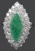 A large marquis emerald and diamond set cluster dress ring