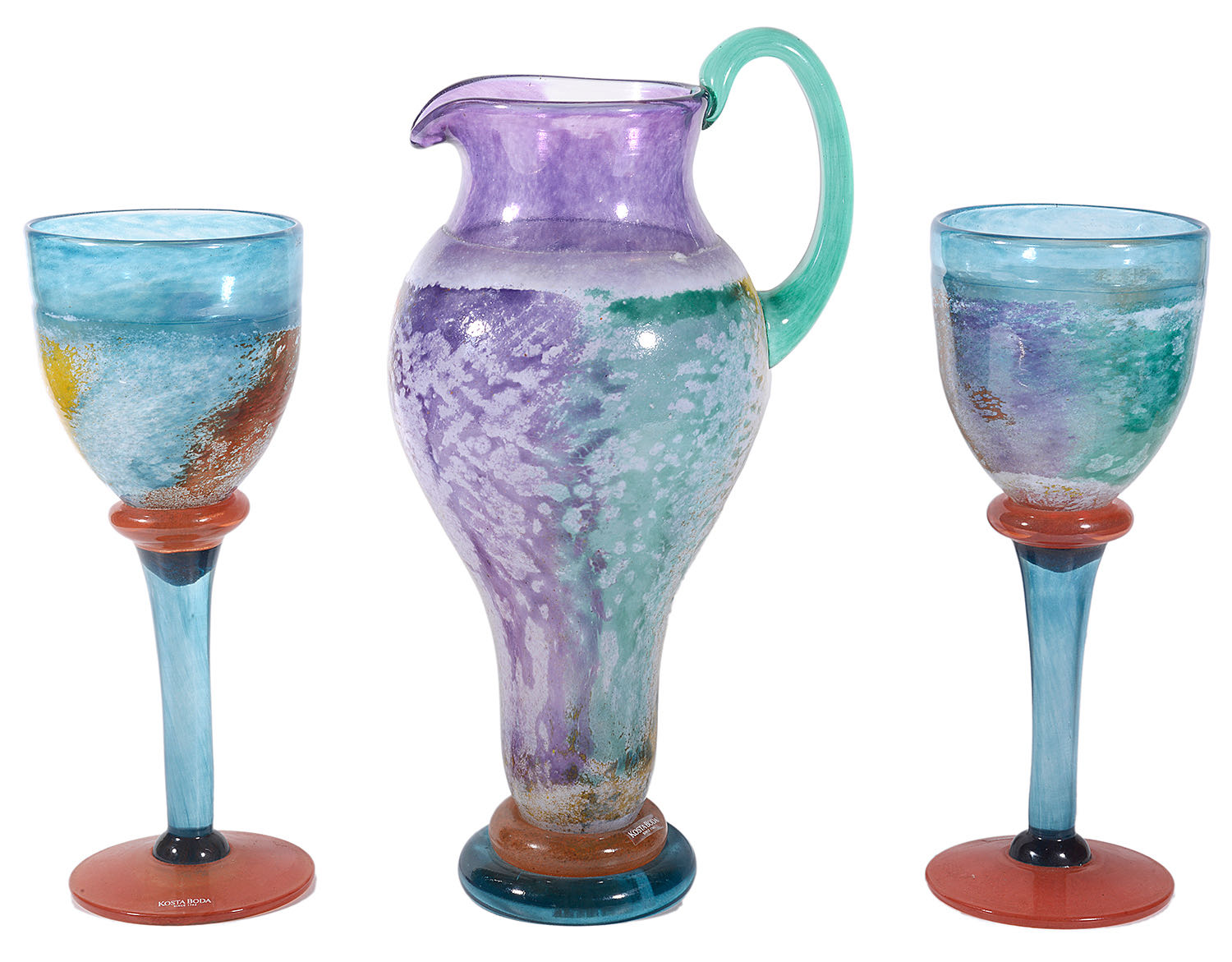 A contemporary Kosta Boda glass Can Can Jug and two matching goblets designed by Kjell Engman