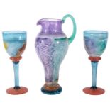 A contemporary Kosta Boda glass Can Can Jug and two matching goblets designed by Kjell Engman