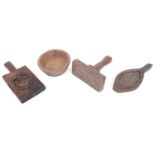 A collection of treen butter moulds and pats