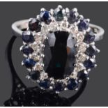 A Continental contemporary sapphire and diamond oval cluster ring