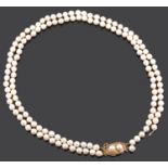 A double row cultured pearl necklace with Chinese yellow metal pearl set fancy clasp