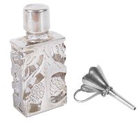 A contemporary silver caged glass scent bottle