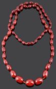 A long graduated cherry amber bead necklace