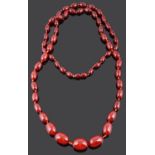 A long graduated cherry amber bead necklace