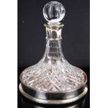A silver mounted crystal ships decanter and a silver ships decanter coaster