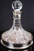 A silver mounted crystal ships decanter and a silver ships decanter coaster