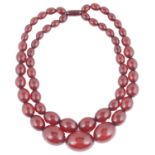 An Art Deco double row cherry amber bead necklace