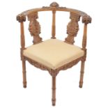An early 20th century carved walnut corner armchair