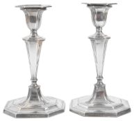 A pair of late Victorian silver candlesticks,