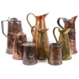 A collection of eight Arts and Crafts mostly Joseph Sankey & Son copper and brass ewers and jugs