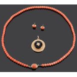 A delicate coral bead necklace and ear studs