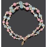 An attractive carved pink and green tourmaline bead two row necklace