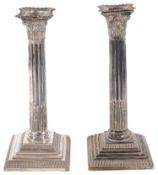 A near pair of Victorian Corinthian column candlesticks