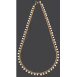 A delicate cultured pearl drop choker necklace