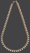 A delicate cultured pearl drop choker necklace