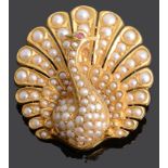 A Continental 18K gold and seed pearl pendant brooch in the form of a peacock