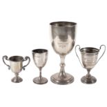 An Edwardian large silver trophy cup and three others