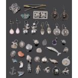 An interesting collection of Victorian silver earrings and a selection of mainly silver charms