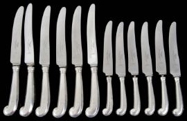 A set of six late Victorian silver handled table and dessert knives with pistol grips