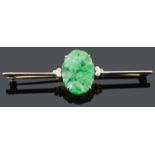 An Art Deco carved green jade and diamond set bar brooch