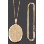 A contemporary oval hinged locket and two 9ct gold chains