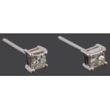 A pair of single stone square cut diamond set ear studs