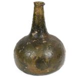 An early 18th century onion shaped green glass wine bottle c.1700