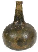 An early 18th century onion shaped green glass wine bottle c.1700