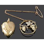 A delicate Edwardian 15ct gold and platinum grape vine brooch and a diamond set heart locket