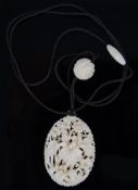 An early 20th century Chinese ivory oval pendant