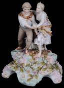 A Sitzendorf porcelain candle holder figure group, late 19th century