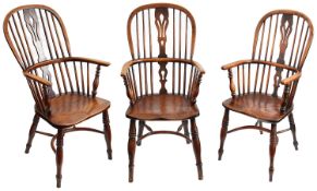 A harlequin set of six early 19th century ash and elm hoop back Windsor armchairs (6)