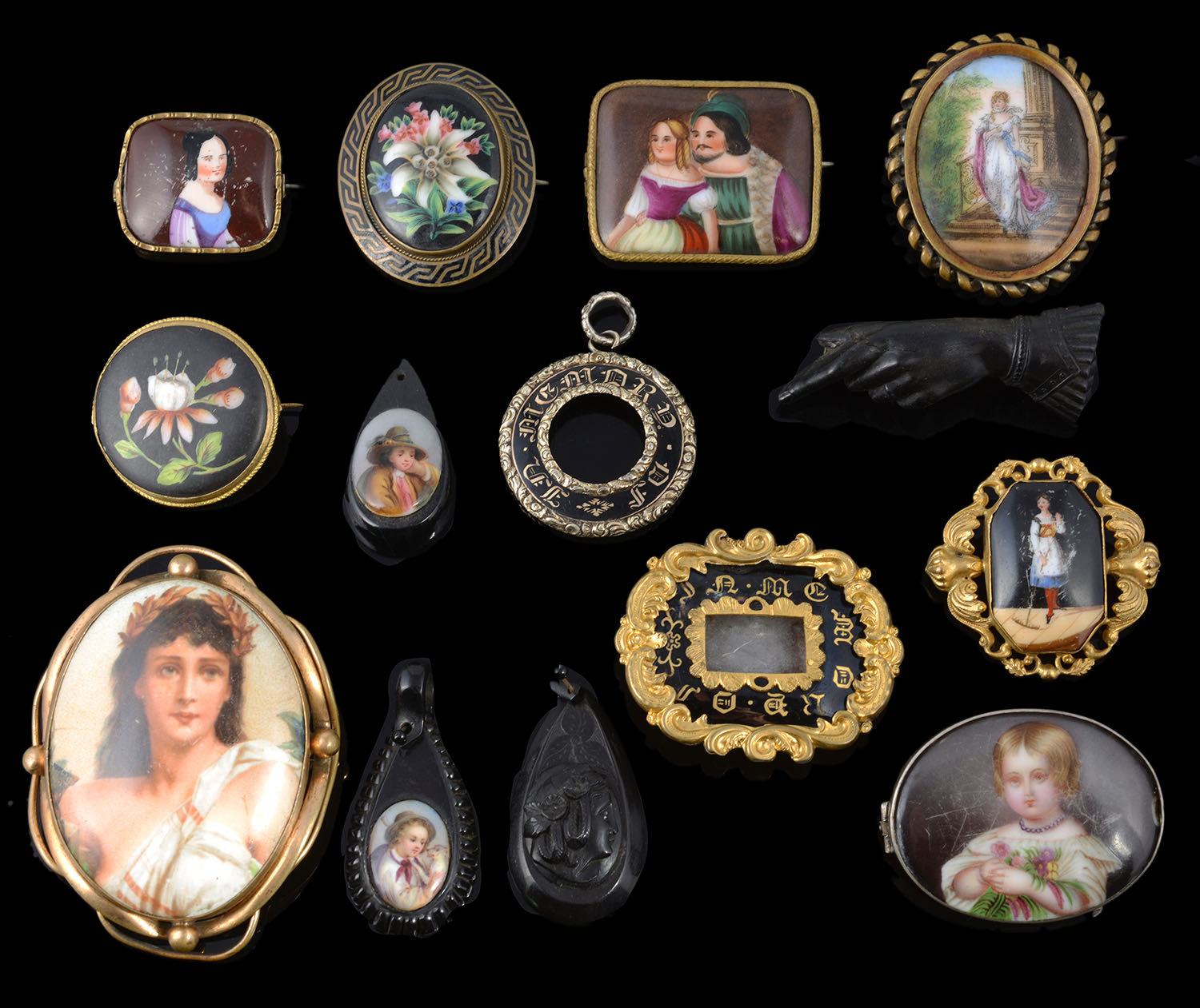 A collection of mainly Victorian painted porcelain brooches