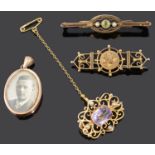 A delicate 9ct gold amethyst set scroll brooch and three other brooches