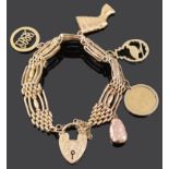 A 9ct gold fancy four bar gate bracelet and charms