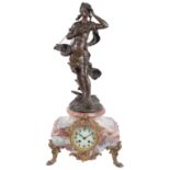 A late 19th century French Louis XV style rouge marble and bronzed Spelter mantel clock