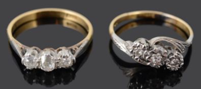 Two three stone diamond set rings (2)