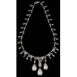 An impressive Edwardian style large baroque pearl drop diamond set necklace