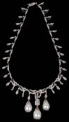 An impressive Edwardian style large baroque pearl drop diamond set necklace