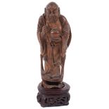 A late 19th Century Chinese carved wooden figure of a sage