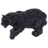 A black painted cast iron doorstop in form of a walking bear