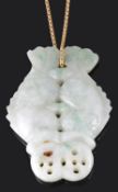 A Chinese mottled green jade twin fish pendant on chain