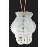 A Chinese mottled green jade twin fish pendant on chain