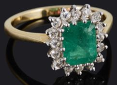 A delicate emerald and diamond set cluster ring