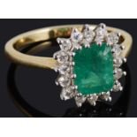 A delicate emerald and diamond set cluster ring