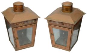 A pair of copper candle wall lanterns