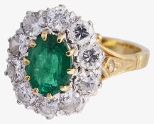 An attractive large emerald and diamond cluster ring