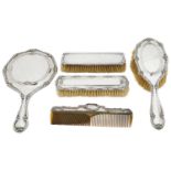 An Edward VII silver three piece silver backed dressing table set; others