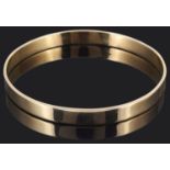 A plain Continental 9ct gold slave bangle